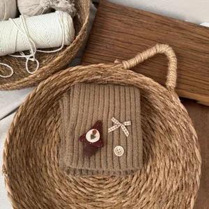 Kids cozy knit winter snood with cute mushroom patch and bow, warm brown baby neck warmer.