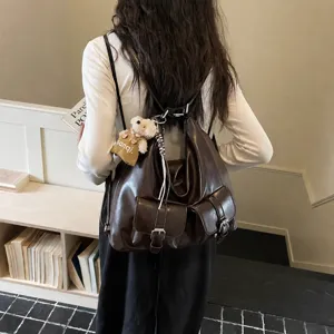 Dark brown leather backpack for women, large capacity stylish tote bag for daily college student use.