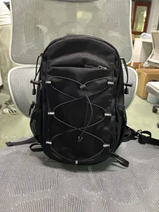 Black hiking cycling backpack with elastic cords and mesh side pockets for outdoor sports.