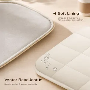 Detail view of the beige quilted puffer laptop sleeve, highlighting soft lining and water-repellent.