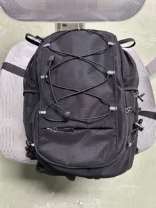 Detail view of black hiking cycling backpack, outdoor sport daypack with elastic bungee cords.