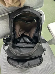 Detailed view of black multi-compartment hiking backpack with interior zipper pockets.