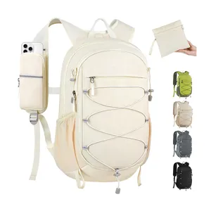 Detail view of lightweight hiking backpack with phone pouch, elastic cord, and foldable design.