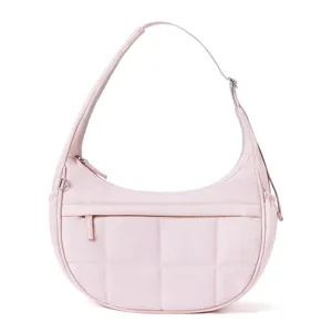 Detailed view of the pink quilted crescent hobo bag, showing puffy texture and adjustable strap.