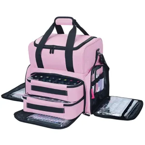 Detailed view of the pink multi-layer nail polish organizer bag with clear storage pockets.