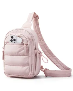 Pink quilted mini sling bag detail view showing front zippered pocket and adjustable strap.