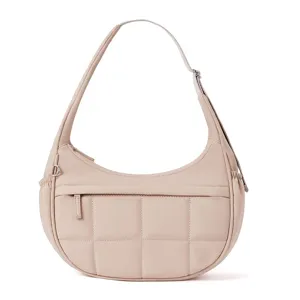 Beige quilted shoulder bag with adjustable strap and zip pocket for daily casual style.