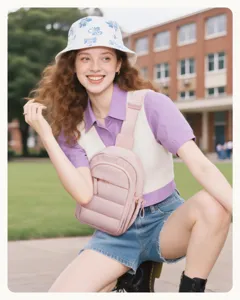 Casual pink sling bag detail shot, compact crossbody design with front zipper pocket.