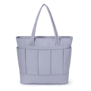 Close-up detail of the light purple utility tote bag with multiple front storage pockets.