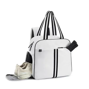 Detail view of white sports backpack featuring separate tennis racket holder and shoe compartment.