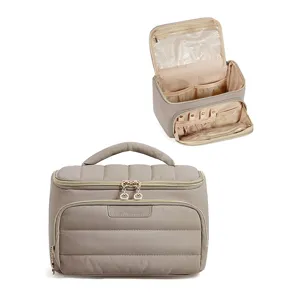 Quilted travel cosmetic bag with large capacity, wide opening, and portable handle for daily use.