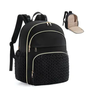 Black quilted diaper backpack detail showcasing durable fabric, gold zippers, and organized interior.
