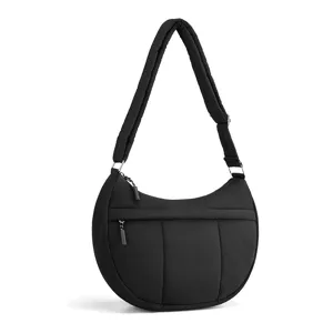 Black quilted nylon crescent shoulder bag for women with adjustable strap and zip pocket.