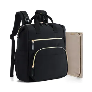 Multifunctional waterproof diaper backpack in black with gold zippers and changing pad.