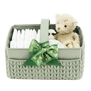 Panier organisateur de couches pour bébé avec poignées nœud et compartiments de rangement.