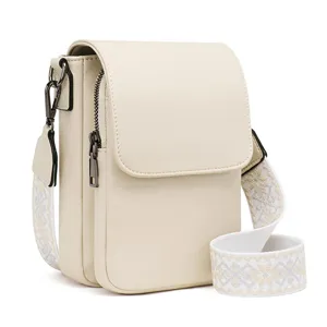 Close-up detail of the stylish PU leather crossbody bag with patterned wide strap and side zip.