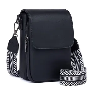 Detailed view of black PU leather crossbody bag featuring a stylish black and white woven strap.