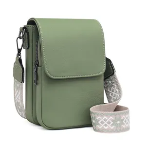 Green PU leather crossbody shoulder bag detail with wide geometric pattern strap and side zip.