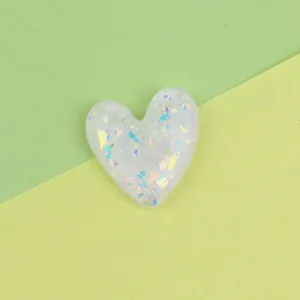 Resin heart glitter patch detail, sparkling sequin DIY accessory for phone case decoration.