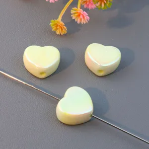 Detail view of smooth heart-shaped loose beads, ideal for DIY jewelry and phone charms.