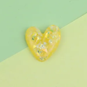 Resin heart flatback charm with colorful sequins, ideal for DIY phone case decoration.
