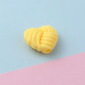 Yellow twisted heart acrylic bead detail, perfect for phone charms and DIY jewelry making.