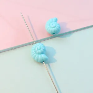 Acrylic conch bead detail shot, light blue shell shape, straight hole DIY jewelry accessory.
