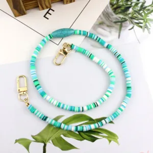 Green and blue heishi bead mask chain lanyard with gold clasps, stylish fashion accessory.