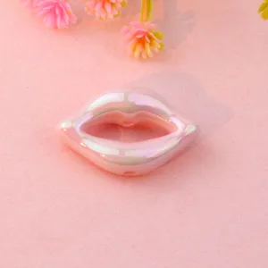 Close-up detail of a pink iridescent acrylic lip bead, perfect for DIY jewelry making.