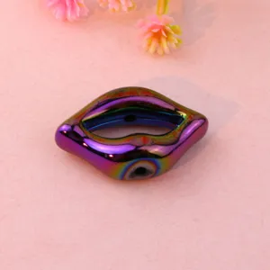 Detailed close-up of iridescent lip-shaped acrylic loose bead for DIY jewelry accessories.