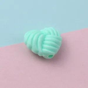 Detail shot of mint green twisted heart acrylic loose bead for jewelry making and phone charms