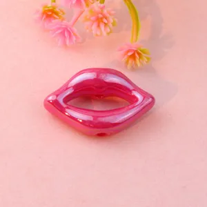 Close-up detail of glossy pink lip shaped acrylic loose bead, perfect for DIY jewelry making.