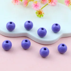 Detail view of purple acrylic round beads, perfect for DIY jewelry crafting and beading.