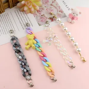 Detailed view of DIY bag chain accessories featuring colorful, pearl, and transparent bear designs.