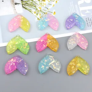 Colorful glitter resin mermaid tail pendants with top hanging hole for DIY jewelry accessories.