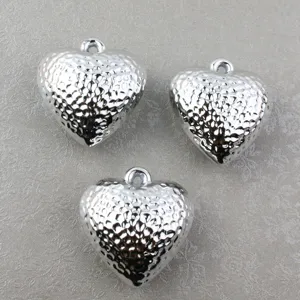 Silver hammered puffy heart pendant detail shot, acrylic DIY jewelry accessory with top hole.