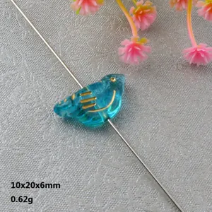 Blue acrylic bird bead with gold-painted lines, perfect for DIY jewelry making and bracelets.