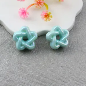 Close-up detail of acrylic hollow star beads for DIY phone chains and jewelry crafts.