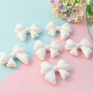 White acrylic bow loose beads with holes, perfect for DIY phone charms, jewelry making and crafts.