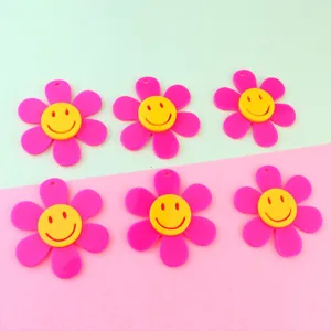 Acrylic smiley face flower pendant detail view, pink and yellow hanging charm accessory