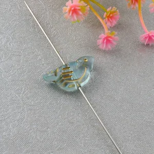 Light blue acrylic bird loose beads with vintage gold details for DIY jewelry making.