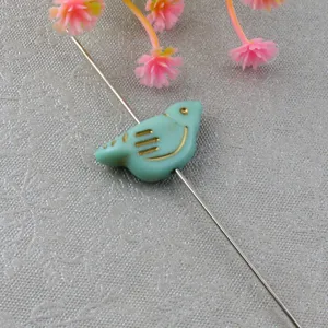 Blue-green bird acrylic loose bead with gold paint, perfect for DIY jewelry making.
