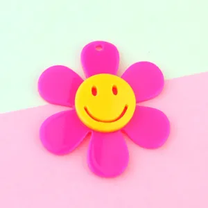Acrylic smiley flower pendant detail, bright pink and yellow charm for DIY jewelry making.