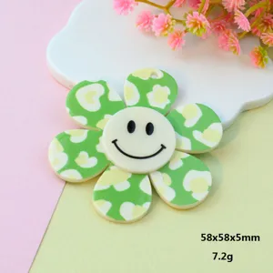 Detail shot of the green acrylic daisy flower pendant, featuring a cute smiley face design.