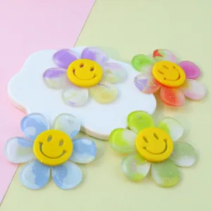 Close-up detail of double-layer acrylic smiley flower charms, colorful floral DIY jewelry pendants.
