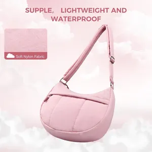 Detail view of pink quilted nylon crossbody bag featuring soft fabric and adjustable strap.