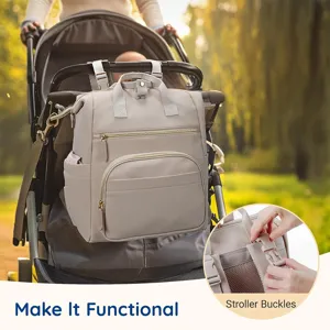 Detailed view of the multi-functional beige diaper backpack hanging securely on a stroller.