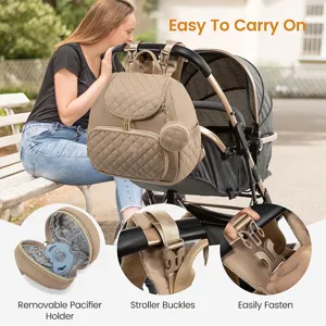 Sac à dos à langer matelassé élégant avec sangles de poussette et porte-tétine.