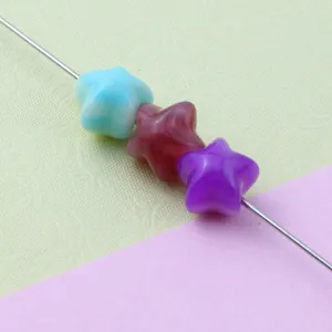 Close-up detail of gradient acrylic star loose beads for DIY jewelry making and crafting.