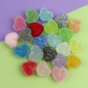 Close-up detail of colorful sparkly heart-shaped acrylic sugar beads for DIY jewelry making.